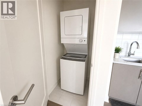 A white toilet with a bidet attachment is installed in a bathroom.