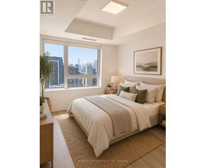 A bedroom with a large bed and a city view through the window.