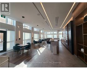 A spacious office with a long table and chairs.