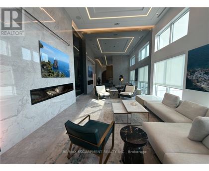 A living room with a fireplace and a painting on the wall.