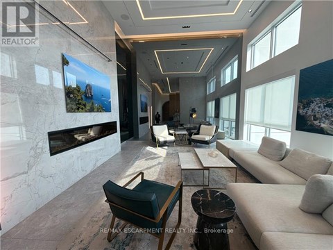 A living room with a fireplace and a painting on the wall.
