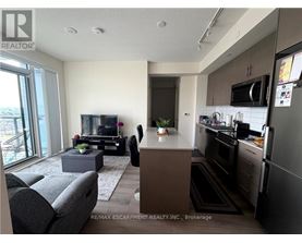 A modern kitchen with dark wood cabinets and stainless steel appliances.