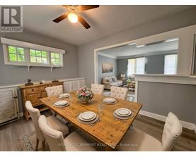 A dining room with a wooden table set for four.