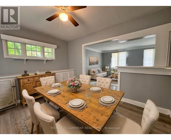 A dining room with a wooden table set for four.