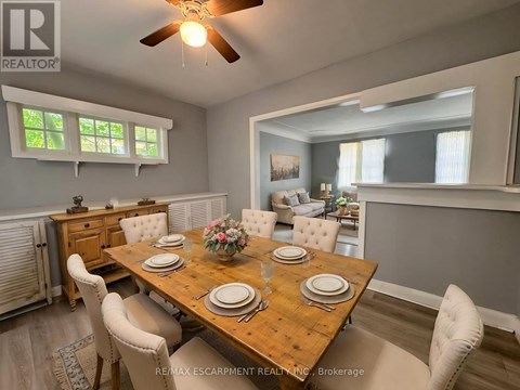 A dining room with a wooden table set for four.