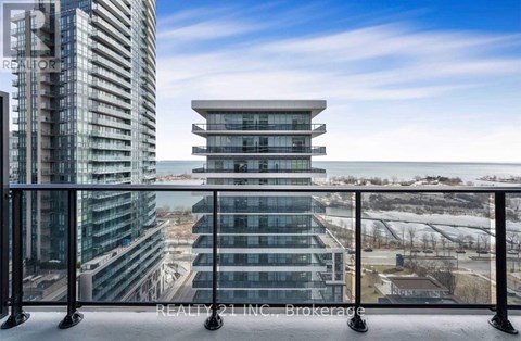 A modern glass building with a balcony overlooking a snowy landscape.