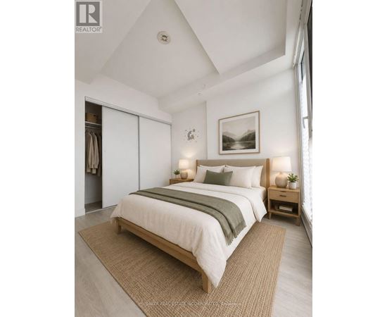 A bedroom with a large bed and a painting on the wall.