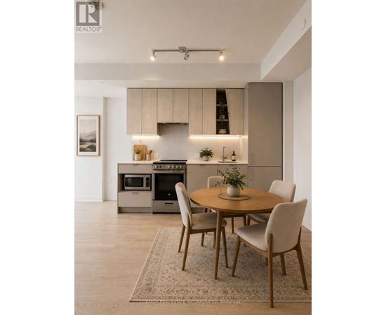 A modern kitchen with a dining table set for four.