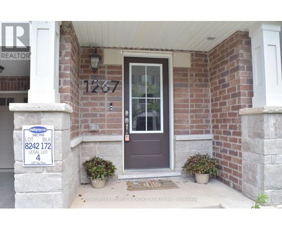 A house with a sign that says "Sale" in front of it.