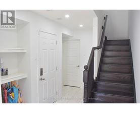 A staircase with a white door in the background.