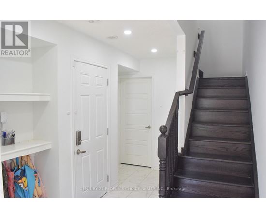 A staircase with a white door in the background.