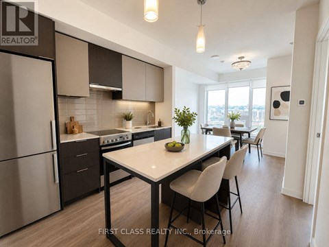 A modern kitchen with a dining table and chairs.