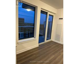 A room with a view of the city through a window.