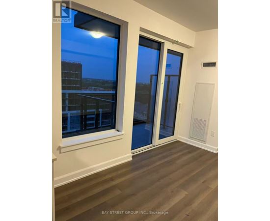 A room with a view of the city through a window.