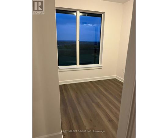 A room with a window overlooking the ocean.