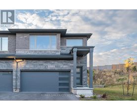 A modern house with a grey facade and a large window.