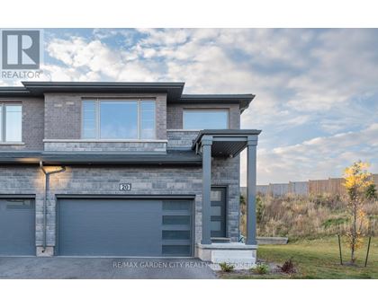 A modern house with a grey facade and a large window.