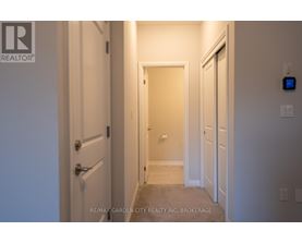 A hallway with a door on the left and a door on the right.