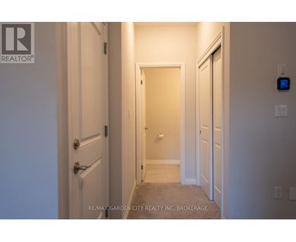 A hallway with a door on the left and a door on the right.