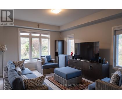 A living room with a leopard print chair and a blue ottoman.