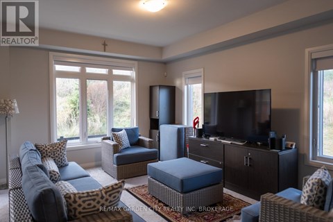A living room with a leopard print chair and a blue ottoman.