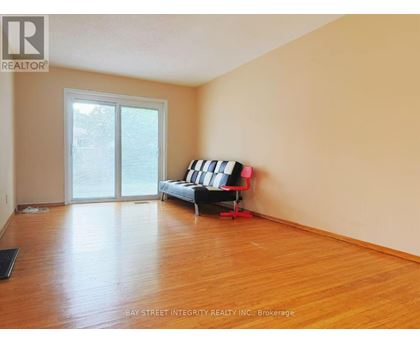 A living room with a sofa and a sliding glass door.