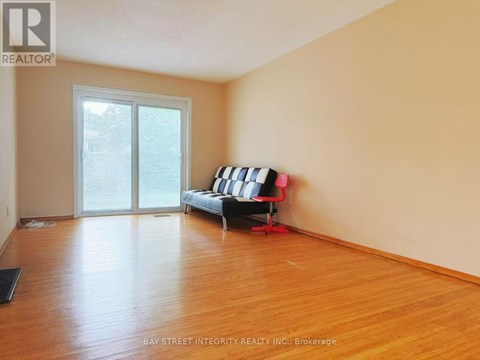 A living room with a sofa and a sliding glass door.