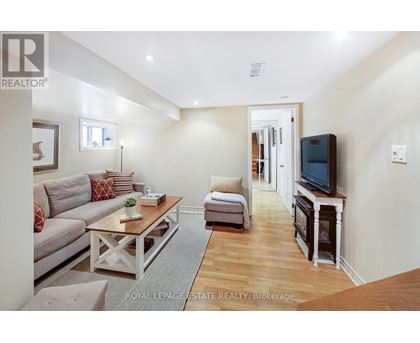 A living room with a grey couch and a wooden coffee table.