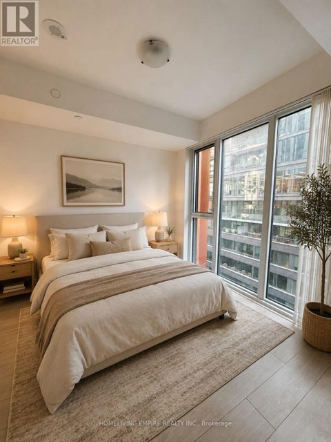 A bedroom with a large bed and a view of the city.