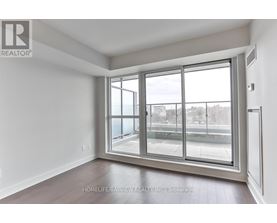 A room with a large window and a sliding glass door.