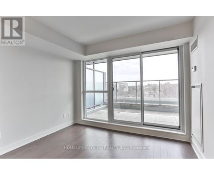 A room with a large window and a sliding glass door.