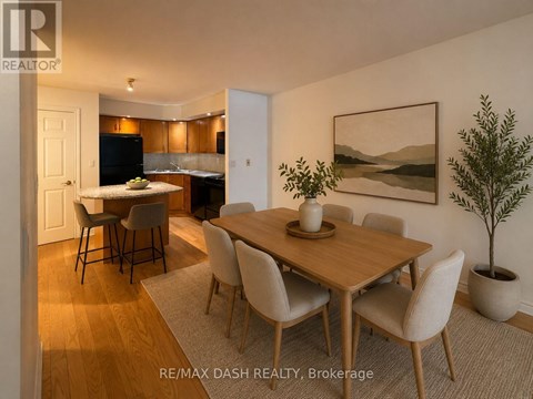 A dining room with a wooden table and chairs.