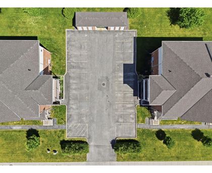 A large building with a parking lot in front of it.