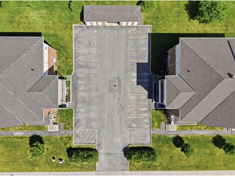 A large building with a parking lot in front of it.