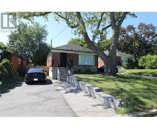 A house with a car parked in front of it.