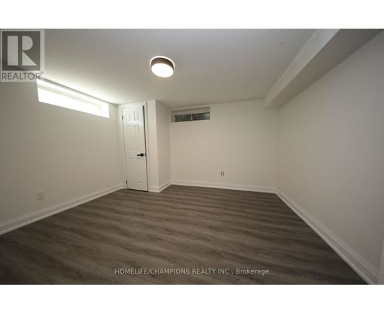A room with a door and a light on the ceiling.