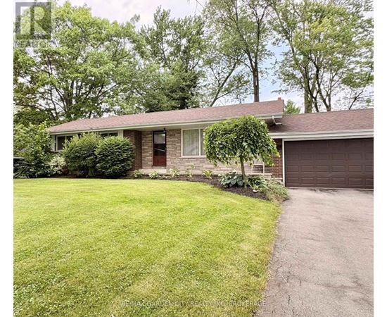 A house with a brown garage door and a green lawn.