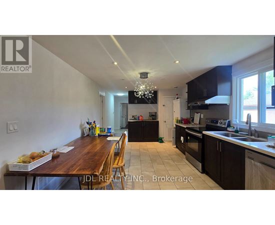 A kitchen with a dining table and chairs in the foreground.