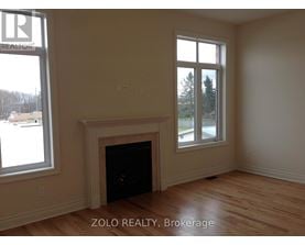 A room with a fireplace and a window.