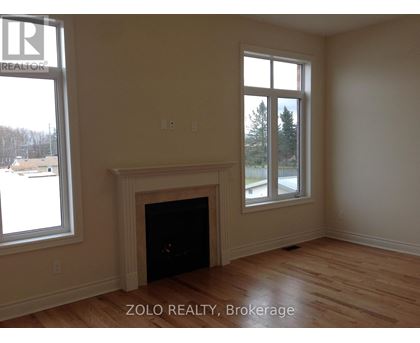 A room with a fireplace and a window.