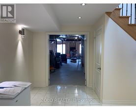 A realtor's office with a view of a living room through an open door.