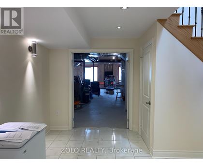 A realtor's office with a view of a living room through an open door.
