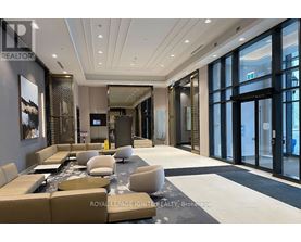 A spacious living room with a large couch and a coffee table.