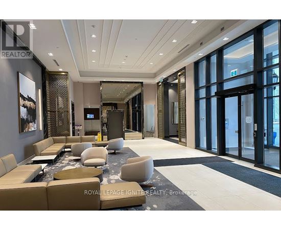 A spacious living room with a large couch and a coffee table.