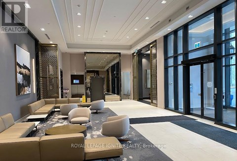 A spacious living room with a large couch and a coffee table.