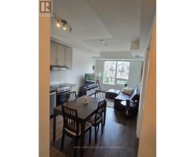 A kitchen with a dining table and chairs.