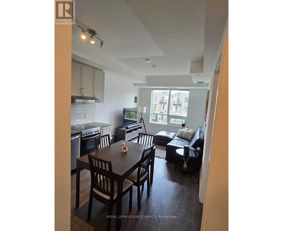 A kitchen with a dining table and chairs.