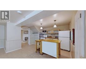A kitchen with white appliances and wooden cabinets.