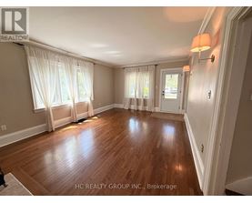 A room with wooden floors and white walls.