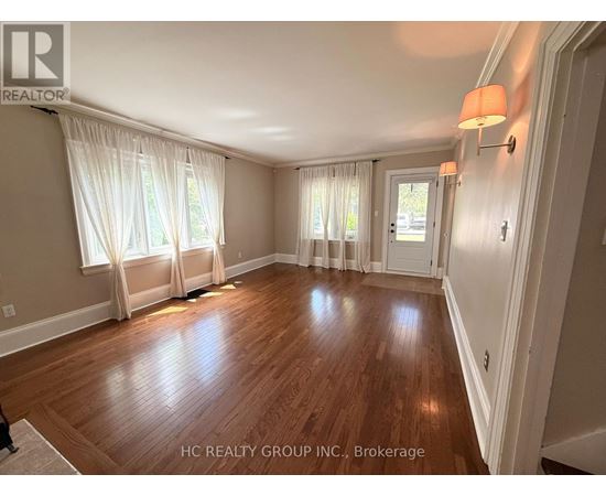 A room with wooden floors and white walls.